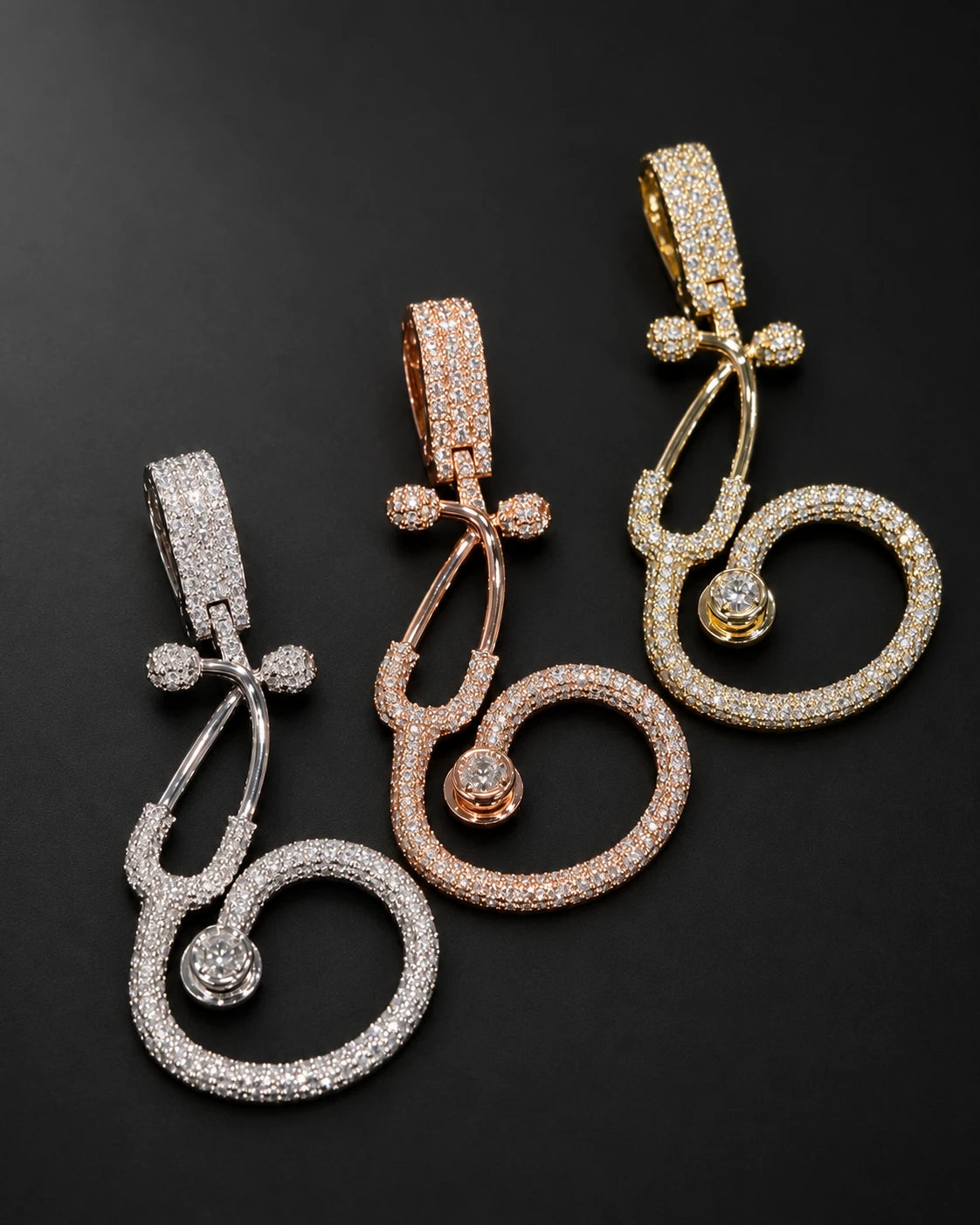 Natural diamond stethoscope pendants in white, yellow and rose 10K gold on a charcoal background