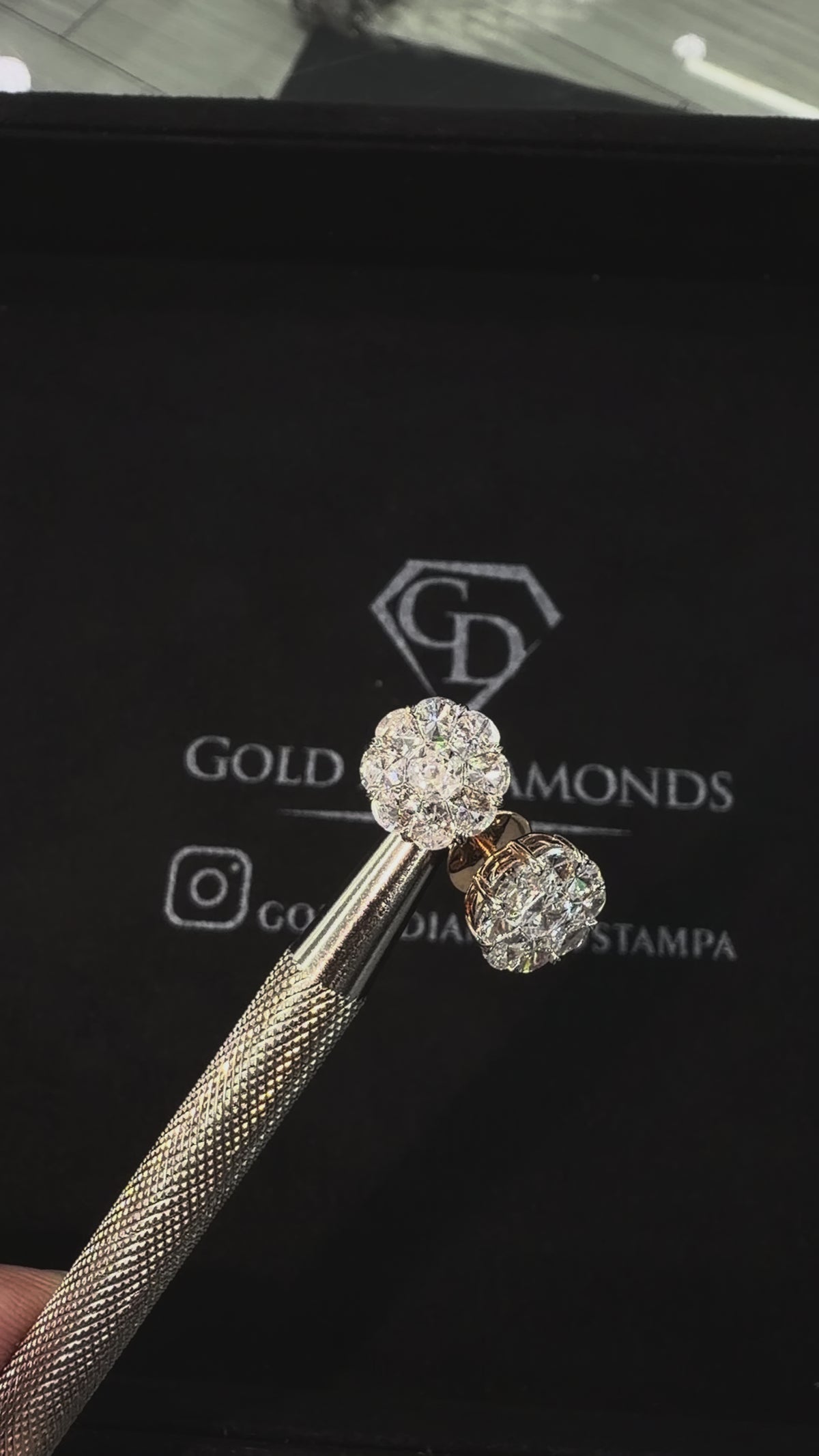 Actual 2.50 CTW natural custom-cut diamond earrings in motion against the black Gold N Diamonds Tampa backdrop
