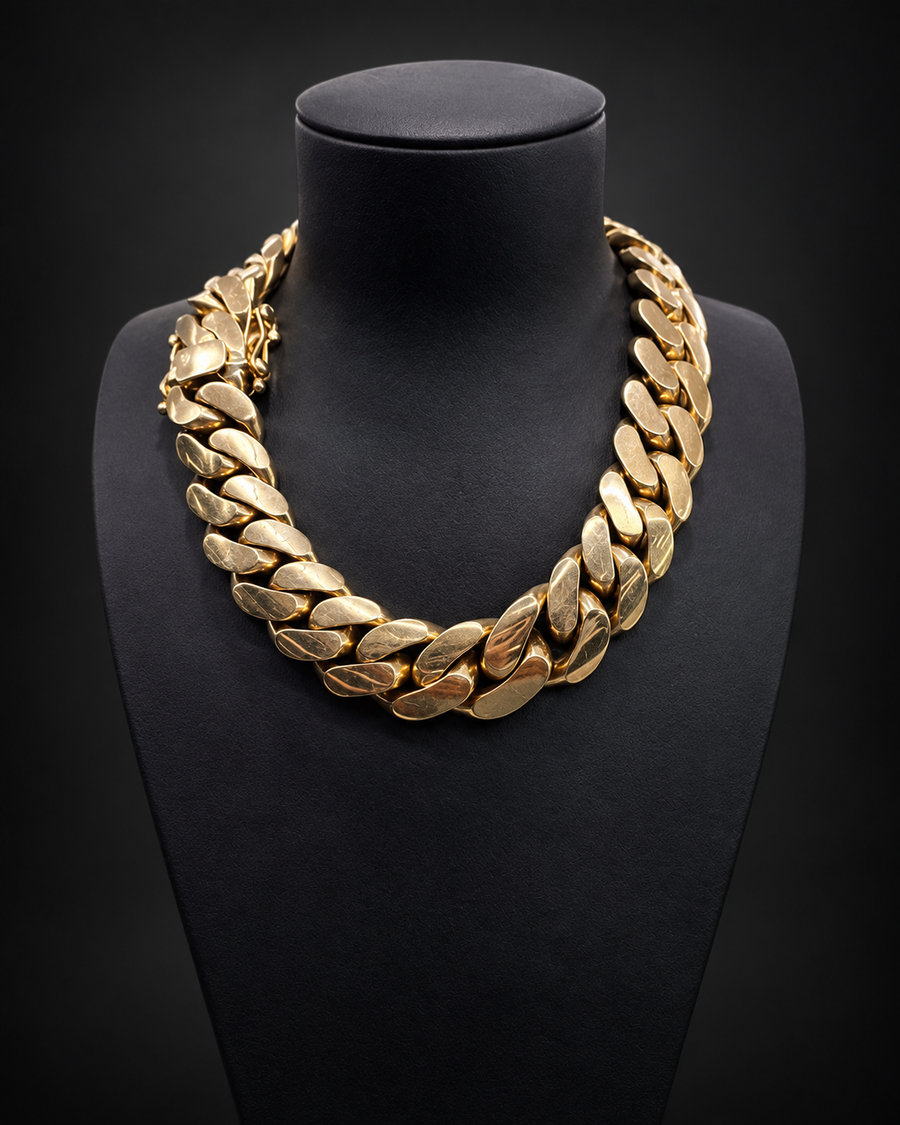 Solid gold Miami Cuban chain on a black display